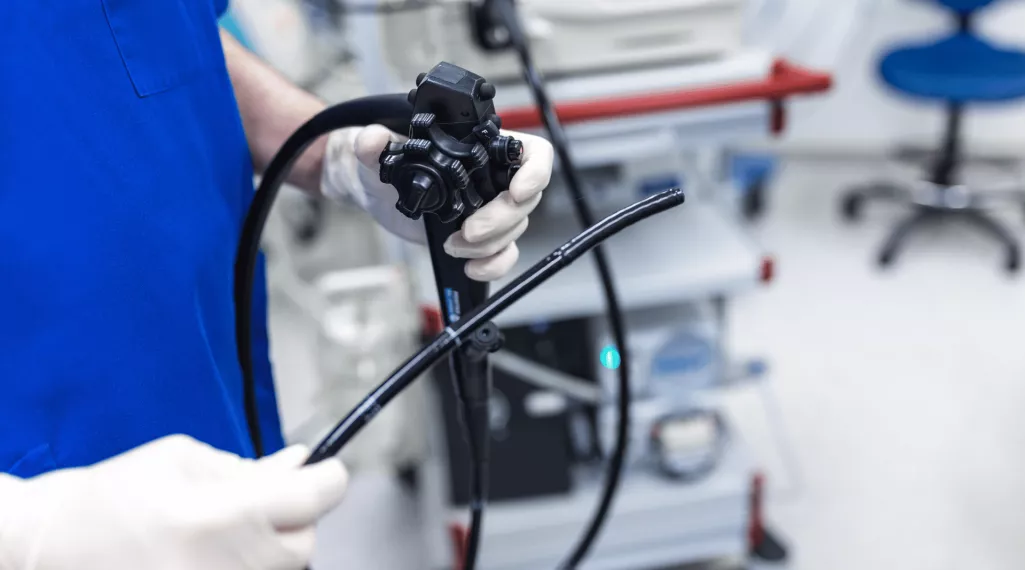A medical professional holds a colonoscope, the instrument used for colonoscopy colorectal cancer screening. 