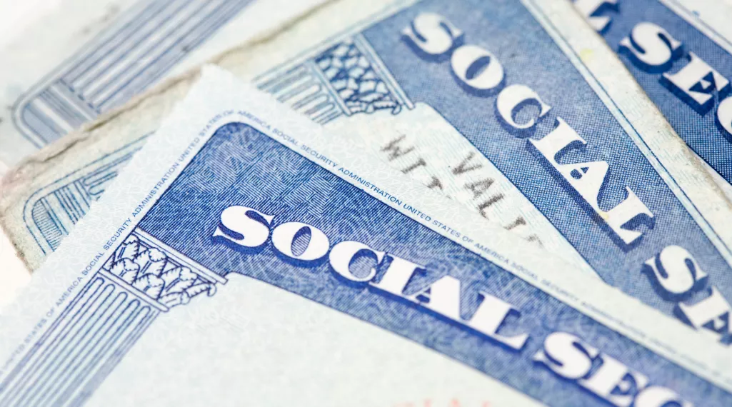 A photo of three social security cards. 